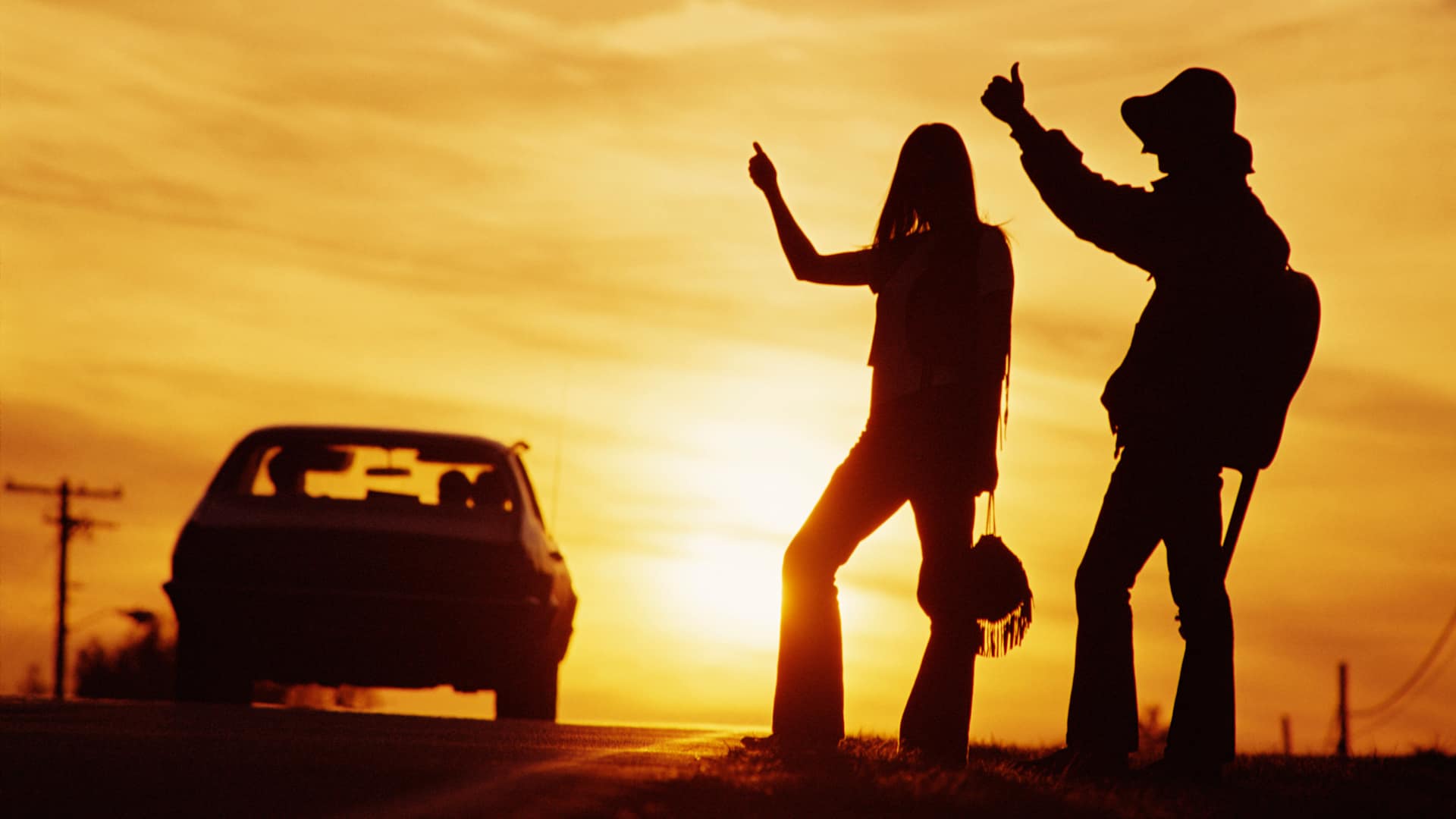 Hitchhikers in sunset.