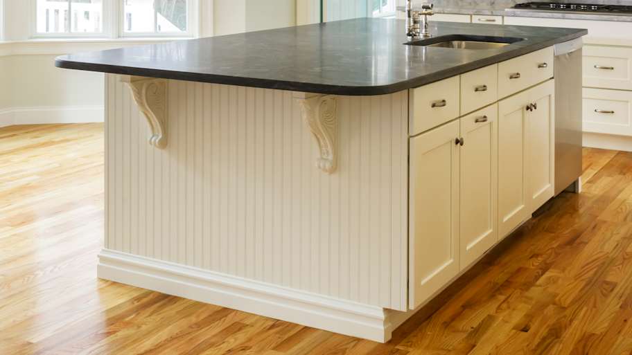 A spacious kitchen with hardwood floor