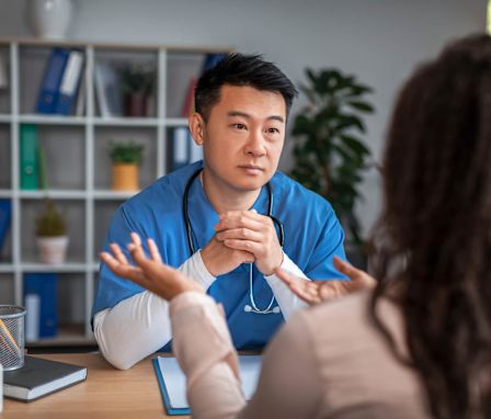 Male nurse speaking to patient