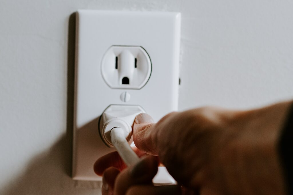 Person plugging into an outlet